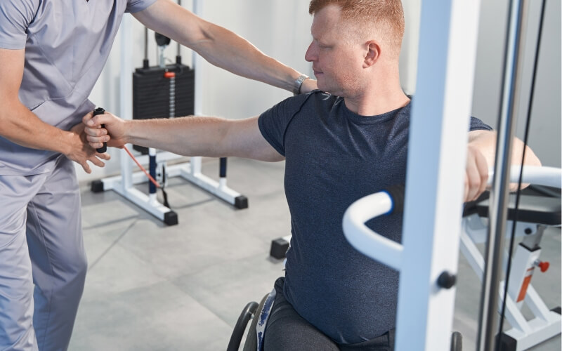 Taylor Mikaelian accredited NDIS exercise physiologist guides a client through resistance training as part of a tailored program in Parramatta. Tailored Exerci Taylor Mikaelian accredited NDIS exercise physiologist guides a client through resistance training as part of a tailored program in Parramatta. Tailored Exercise Physiology offers personalised support for NDIS participants across Greater Parramatta.